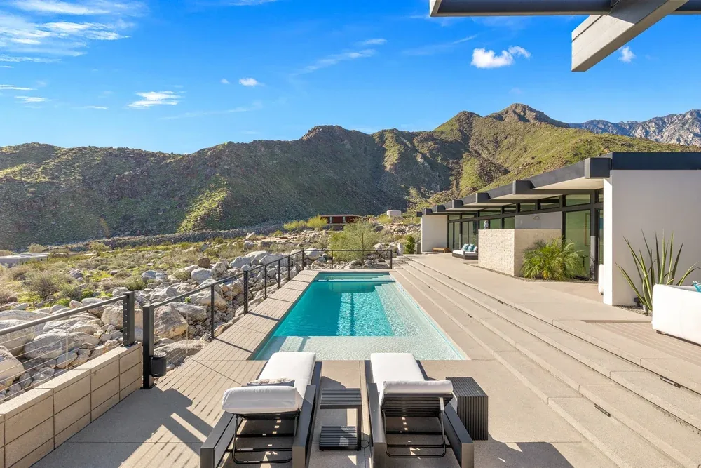 A pool deck facing the green flank of the mountain.